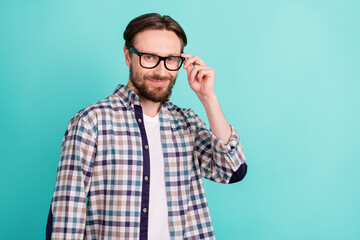 Photo of young handsome man happy positive smile hand touch eyeglasses isolated over teal color background