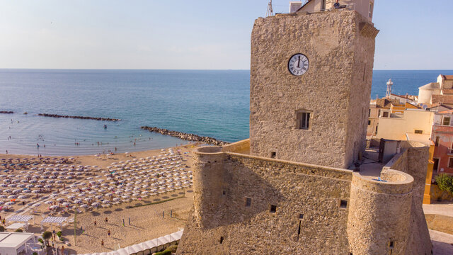 The ancient village and the Castello Svevo castel with the beach in the background during a summer day in Termoli , Molise , Italy