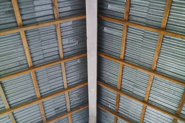 the roof of a house with a wooden frame and zinc covering