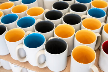 Obraz na płótnie Canvas close up of colorful ceramic mug on shelf