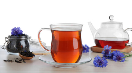 Cornflower tea and fresh flowers on wooden table