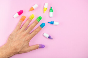 Male hand colorful nails, different colours on pink background. Diversity concept, LGBT icon,...