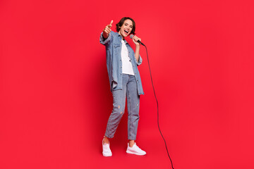 Full body photo of young woman happy positive smile star stage concert singer point finger you...