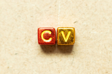 Metallic color alphabet letter block in word CV (Abbreviation of curriculum vitae) on wood...