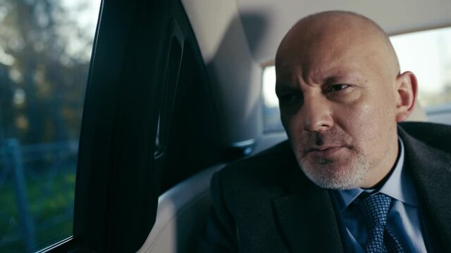Disappointed man riding in car.