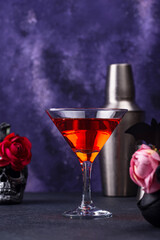 Halloween martini cocktail on purple background
