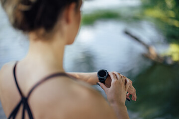 Young woman, looking at her heart rate.