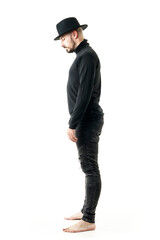 Side view of sad grieving man in black clothes with hat bowing head with closed eyes. Full length portrait isolated on white background