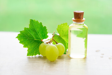 Bottles with grape oil on table