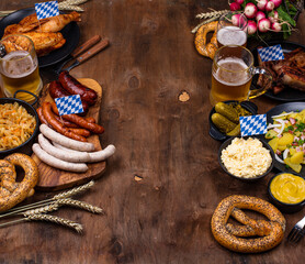 Oktoberfest dishes with beer, pretzel and sausage