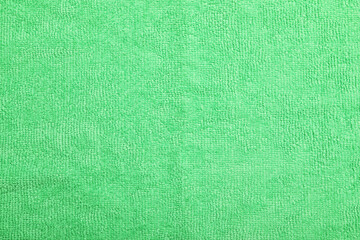 Light green microfiber cloth as background, top view