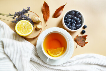 Lemon lavender tea and blueberries on the pastel beige background. Stay healthy in flu winter...
