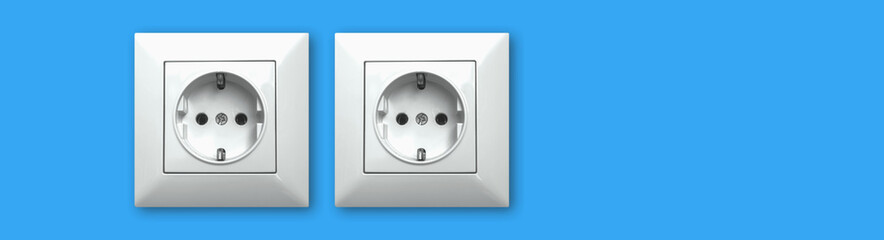 Banner with electric outlet, electricity technology concept background, modern interior with blue wall, copy space photo