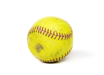 Used slowpitch softball. Small ball used for team sports. Yellow durable leather or polyester material with red chevron stichig. Isolated on white. Selective focus.