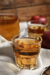 Glass of delicious apple cider on table. Space for text
