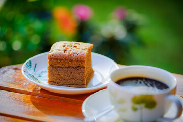 Coffee cake and hot coffee in the flower garden, refreshing in the morning
