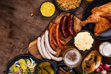 Oktoberfest dishes with beer, pretzel and sausage