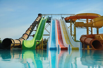 Beautiful view of water park with colorful slides and swimming pool on sunny day