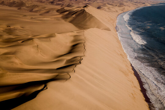 Aerial view of Sandwich Harbour, where the Namib desert meets the Atlantic coast, near Walvis Bay in Namibia, Africa.
