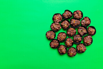 Top view chocolate muffin cupcakes isolated on green background