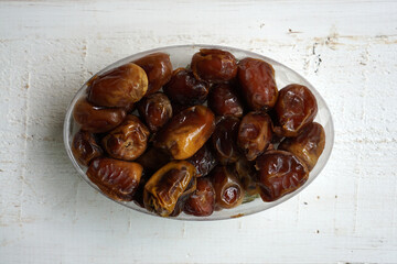Packaged dates on a white wooden table         