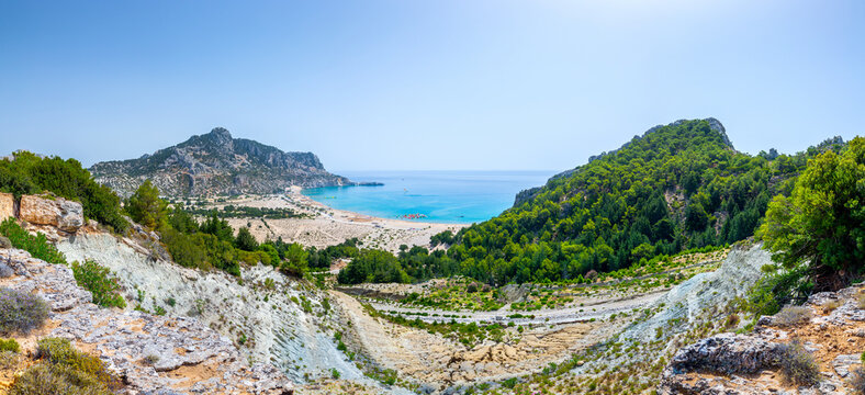 Tsambika Beach in a closed bay. Famous place for beach leisure and multifarious water attraction. Vacation on Greece islands in Aegean and Mediterranean sea. Kolympia. East Rhodes. Greece