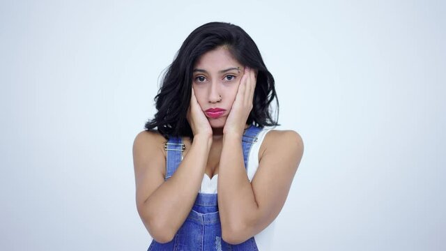Facepalm, sorrow emotions. Upset worried brunette woman slapping hand on face and expressing regret, blaming herself for troubles, feeling helpless. indoor studio shot isolated on white background. 