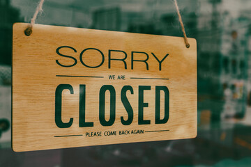 The shop sign is closed on the glass door,business closure concept during coronavirus