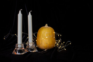 Halloween pumpkin with candle on black background