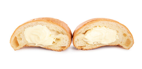 Halves of delicious croissant with cream on white background