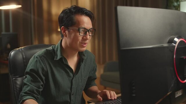 Asian Male Works His Personal Computer And Celebrating, He Works At Night 
