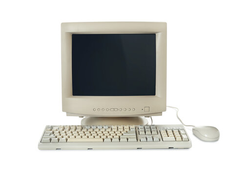 Old computer monitor, keyboard and mouse on white background