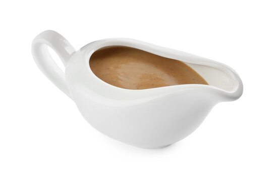 Delicious turkey gravy in sauce boat isolated on white