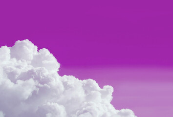 Pop art surreal style pure white fluffy clouds on gradient purple colored sky with copy space