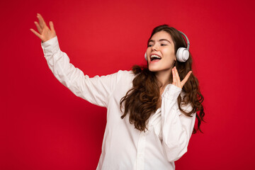 Photo of beautiful happy smiling young brunette woman wearing white shirt and optical glasses...