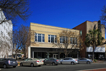 Generic office business building along street with parked cars
