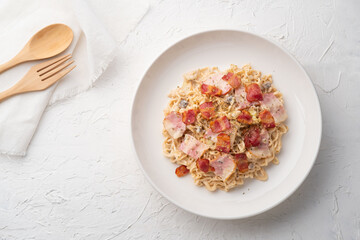 instant noodle carbonara sauce mushroom with bacon in white plate.fusion food.Top view