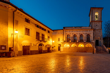 Fototapeta na wymiar Piazza San Benedetto square in the historic center of Norcia, Italy, illuminated by evening lights
