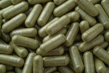 Close up Andrographis Paniculata capsules,Thai herbs for background.selective focus