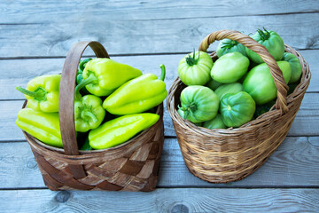 Vegetables in the basket. Wicker baskets are filled with fresh vegetables. Harvesting tomatoes and peppers.