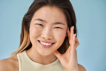 Woman putting her hand at her face and posing while looking at the camera