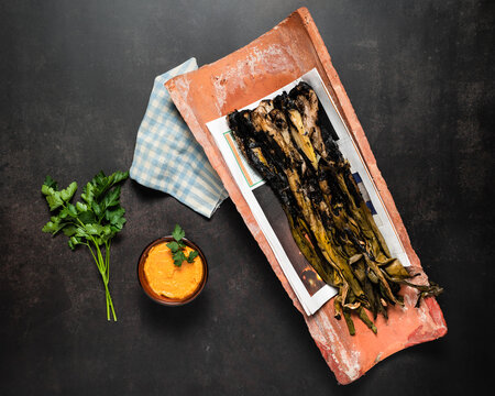 Grilled spring onions with romesco sauce in a cenital view. Spanish cuisine