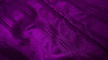 Fototapeta na wymiar close up dark purple satiny blanket or silky fabric background with beautiful creased pattern. crumpled violet silk bed sheet background. close up purple velvet of rippled fabric.