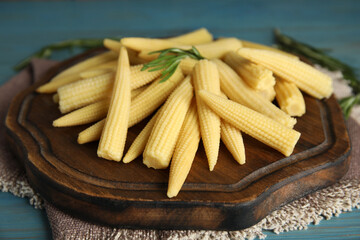 Fresh baby corn cobs on blue wooden table