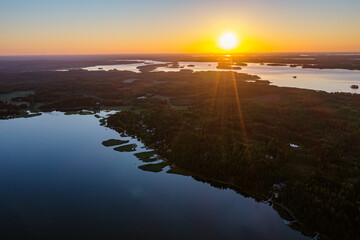 Forested islands in the sea at sunrise. Nature of Scandinavia, Finland. Photo from the drone.