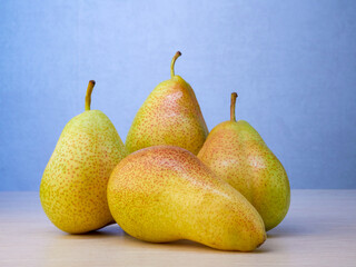 A green pear with a leaf highlighted on a white background. A Path For Pruning Pears. Professional studio photography