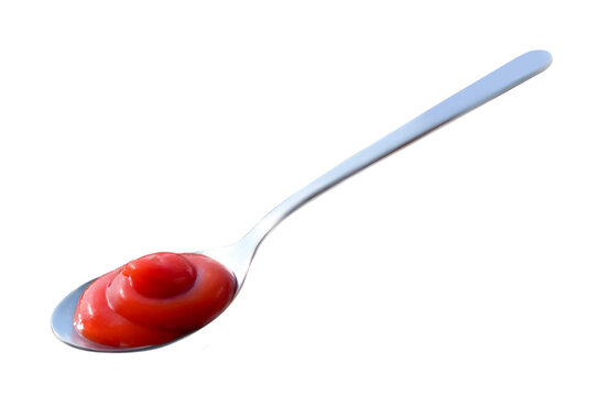 Ketchup red splashes in spoon isolated on white background. Tomato sauce top view. High resolution photo