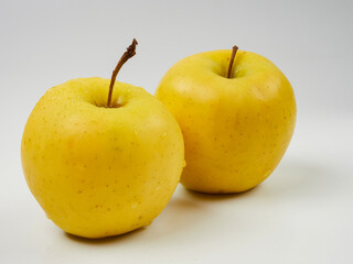 Fresh yellow apple with water drops, isolated on a white background