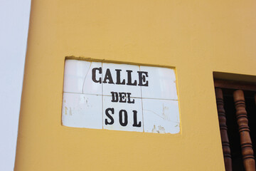 The heavily weather beaten tile street marker identifying Calle de Sol in Old San Juan, Puerto Rico