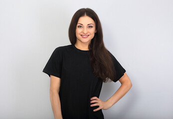 Happy toothy smiling woman posing in blank black t-shirt on blue background - 446831002